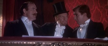 Movie still from “The Private Life of Sherlock Holmes” (1970), directed by Billy Wilder – A man in a top hat and a tuxedo; Medium shot, Low angle