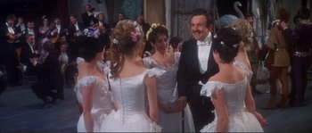 Movie still from “The Private Life of Sherlock Holmes” (1970), directed by Billy Wilder – A group of people standing next to each other in formal wear; Medium shot, Over the shoulder angle
