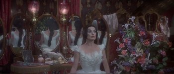 Movie still from “The Private Life of Sherlock Holmes” (1970), directed by Billy Wilder – A woman dressed as the bride of dracula in front of a mirror; Medium shot, Over the shoulder angle