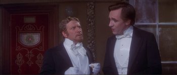 Movie still from “The Private Life of Sherlock Holmes” (1970), directed by Billy Wilder – Two men in tuxedos looking at each other in front of a mirror; Medium shot, Low angle