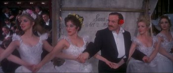 Movie still from “The Private Life of Sherlock Holmes” (1970), directed by Billy Wilder – A man and a woman holding hands in front of a wall; Medium shot, High angle