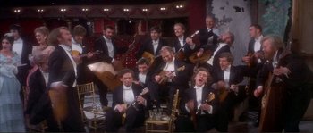 Movie still from “The Private Life of Sherlock Holmes” (1970), directed by Billy Wilder – A group of men in tuxedos holding instruments; Wide shot, High angle