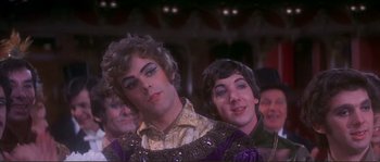 Movie still from “The Private Life of Sherlock Holmes” (1970), directed by Billy Wilder – A man in a purple and white shirt and a woman in a purple and white dress; Close Up shot, High angle