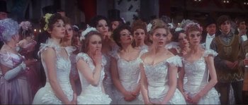 Movie still from “The Private Life of Sherlock Holmes” (1970), directed by Billy Wilder – A group of women in wedding dresses standing in a crowd; Medium shot, High angle
