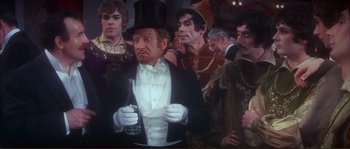 Movie still from “The Private Life of Sherlock Holmes” (1970), directed by Billy Wilder – A group of people dressed up in costumes; Medium shot, High angle