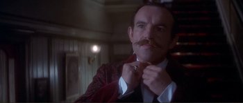 Movie still from “The Private Life of Sherlock Holmes” (1970), directed by Billy Wilder – A person tying a tie; Close Up shot, Low angle