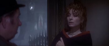 Movie still from “The Private Life of Sherlock Holmes” (1970), directed by Billy Wilder – A woman standing in front of a window in a dark room; Close Up shot, High angle