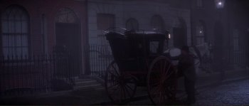 Movie still from “The Private Life of Sherlock Holmes” (1970), directed by Billy Wilder – A horse drawn carriage parked in front of a building; Wide shot, High angle