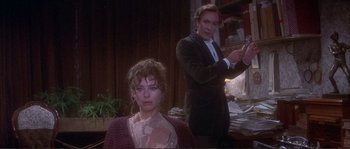 Movie still from “The Private Life of Sherlock Holmes” (1970), directed by Billy Wilder – A man and a woman are standing in front of a mirror; Medium shot, Over the shoulder angle