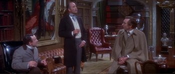 Movie still from “The Private Life of Sherlock Holmes” (1970), directed by Billy Wilder – A man in a suit and tie talking to another man in a suit and tie; Medium shot, Over the shoulder angle
