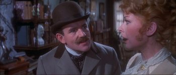 Movie still from “The Private Life of Sherlock Holmes” (1970), directed by Billy Wilder – A man with a mustache wearing a top hat; Close Up shot, Over the shoulder angle