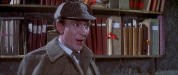 Movie still from “The Private Life of Sherlock Holmes” (1970), directed by Billy Wilder – A person wearing a hat and a coat; Close Up shot, Over the shoulder angle