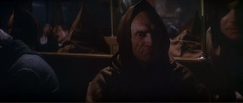 Movie still from “The Private Life of Sherlock Holmes” (1970), directed by Billy Wilder – A man in a hooded jacket stares at the camera; Close Up shot, Low angle