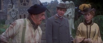 Movie still from “The Private Life of Sherlock Holmes” (1970), directed by Billy Wilder – Two older men standing next to each other in front of a statue; Medium shot, Over the shoulder angle