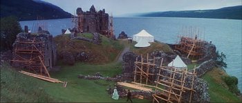 Movie still from “The Private Life of Sherlock Holmes” (1970), directed by Billy Wilder – A group of people standing on top of a grass covered hillside; Extreme Wide shot, Low angle