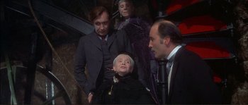 Movie still from “The Private Life of Sherlock Holmes” (1970), directed by Billy Wilder – A group of people standing next to each other in a room; Medium shot, Low angle