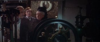Movie still from “The Private Life of Sherlock Holmes” (1970), directed by Billy Wilder – An older woman wearing a black hat and a black dress; Medium shot, High angle