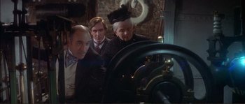 Movie still from “The Private Life of Sherlock Holmes” (1970), directed by Billy Wilder – A group of people standing next to each other in a room; Medium shot, High angle