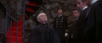 Movie still from “The Private Life of Sherlock Holmes” (1970), directed by Billy Wilder – A man in a black suit and a man in a black suit and a man in a black suit and a man in a black suit; Medium shot, Low angle