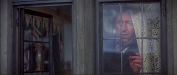 Movie still from “The Private Life of Sherlock Holmes” (1970), directed by Billy Wilder – A man is looking out of a window; Medium shot, Over the shoulder angle