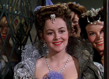 Movie still from “The Private Lives of Elizabeth and Essex” (1939), directed by Michael Curtiz – A person wearing a dress; Close Up shot, Over the shoulder angle