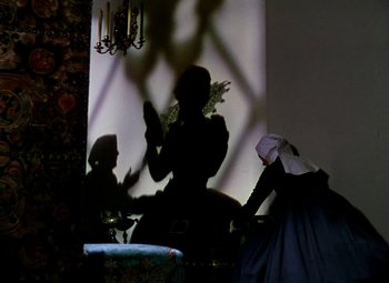 Movie still from “The Private Lives of Elizabeth and Essex” (1939), directed by Michael Curtiz – Two women in medieval garb in front of a mirror; Wide shot, Low angle