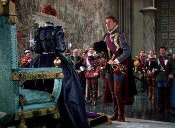 Movie still from “The Private Lives of Elizabeth and Essex” (1939), directed by Michael Curtiz – A man and a woman dressed in medieval clothing; Wide shot, Over the shoulder angle