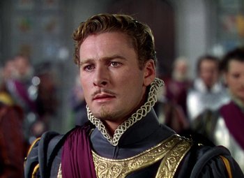 Movie still from “The Private Lives of Elizabeth and Essex” (1939), directed by Michael Curtiz – A person wearing a costume; Close Up shot, Over the shoulder angle