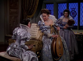 Movie still from “The Private Lives of Elizabeth and Essex” (1939), directed by Michael Curtiz – A group of women dressed up in historical clothing; Medium shot, High angle