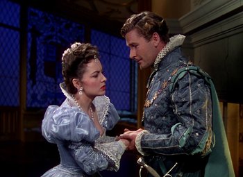 Movie still from “The Private Lives of Elizabeth and Essex” (1939), directed by Michael Curtiz – A man and a woman dressed in medieval clothing; Medium shot, Over the shoulder angle