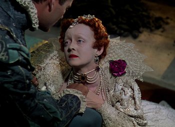 Movie still from “The Private Lives of Elizabeth and Essex” (1939), directed by Michael Curtiz – A man and a woman dressed up in costume; Close Up shot, High angle