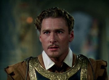 Movie still from “The Private Lives of Elizabeth and Essex” (1939), directed by Michael Curtiz – A person wearing a costume; Close Up shot, Over the shoulder angle