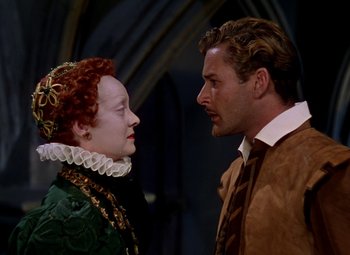 Movie still from “The Private Lives of Elizabeth and Essex” (1939), directed by Michael Curtiz – A man and a woman face to face in front of an archway; Close Up shot, Over the shoulder angle