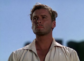 Movie still from “The Private Lives of Elizabeth and Essex” (1939), directed by Michael Curtiz – A person wearing a white shirt; Close Up shot, Low angle