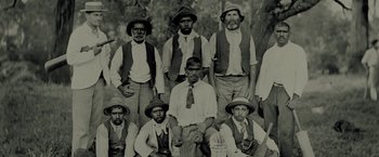 Movie still from “The Proposition” (2005), directed by John Hillcoat – A group of men wearing hats and ties posing for a picture; Medium shot, High angle