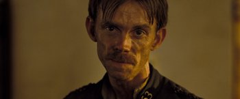 Movie still from “The Proposition” (2005), directed by John Hillcoat – A person wearing a uniform; Close Up shot, Over the shoulder angle