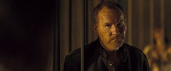 Movie still from “The Proposition” (2005), directed by John Hillcoat – A person looking at a camera; Close Up shot, Over the shoulder angle