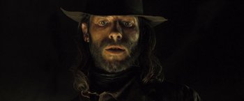 Movie still from “The Proposition” (2005), directed by John Hillcoat – A person wearing a hat; Close Up shot, Low angle