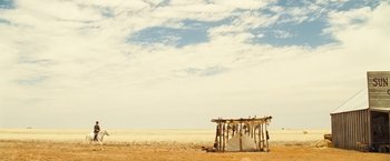 Movie still from “The Proposition” (2005), directed by John Hillcoat – An empty tent in the middle of a desert landscape; Extreme Wide shot, Low angle