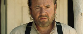 Movie still from “The Proposition” (2005), directed by John Hillcoat – A person with a beard; Close Up shot, Low angle
