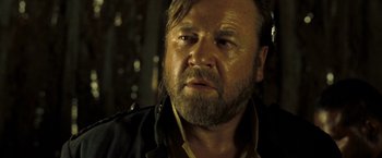 Movie still from “The Proposition” (2005), directed by John Hillcoat – A person with a beard; Close Up shot, Over the shoulder angle