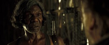 Movie still from “The Proposition” (2005), directed by John Hillcoat – An older man with a gun in his hand; Close Up shot, Over the shoulder angle