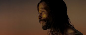 Movie still from “The Proposition” (2005), directed by John Hillcoat – A person with long hair and a beard; Close Up shot, Low angle