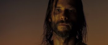 Movie still from “The Proposition” (2005), directed by John Hillcoat – A person with long hair; Close Up shot, Low angle