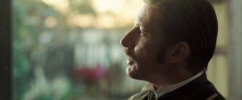 Movie still from “The Proposition” (2005), directed by John Hillcoat – A man's face looking into the distance; Close Up shot, Over the shoulder angle