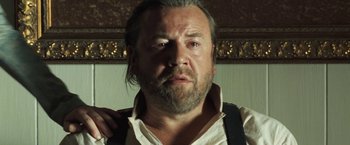 Movie still from “The Proposition” (2005), directed by John Hillcoat – A person with a beard and mustache; Close Up shot, Low angle