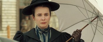 Movie still from “The Proposition” (2005), directed by John Hillcoat – A woman with a hat and a umbrella; Close Up shot, Low angle