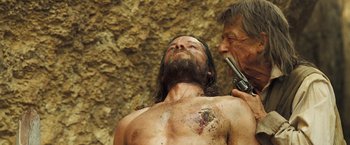 Movie still from “The Proposition” (2005), directed by John Hillcoat – A man is shaving another man's beard; Close Up shot, Over the shoulder angle