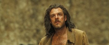 Movie still from “The Proposition” (2005), directed by John Hillcoat – A person with long hair; Close Up shot, Low angle