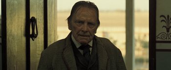 Movie still from “The Proposition” (2005), directed by John Hillcoat – An old man wearing a suit and tie; Close Up shot, Over the shoulder angle